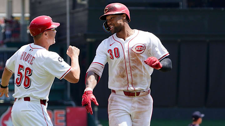 Cincinnati Reds centerfielder Will Benson (30) smiles as he passes Cincinnati Reds third base coach J.R. House (56) after hitting homer in the seventh inning of a MLB game between the Cincinnati Reds and Atlanta Braves, Friday, Aug. 1, 2025, at Great American Ball Park in Downtown Cincinnati. Reds won 3-2.