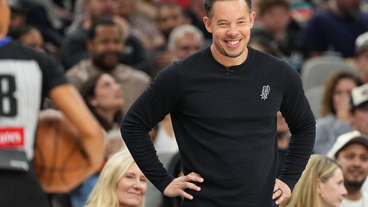 Apr 8, 2026; San Antonio, Texas, USA; San Antonio Spurs head coach Mitch Johnson smiles during the first half against the Portland Trail Blazers at Frost Bank Center. Mandatory Credit: Scott Wachter-Imagn Images