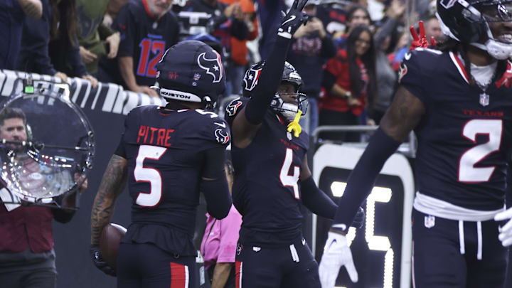 Dec 14, 2025; Houston, Texas, USA; Houston Texans cornerback Kamari Lassiter (4) reacts after making an interception during the game against the Arizona Cardinals at NRG Stadium. Mandatory Credit: Troy Taormina-Imagn Images