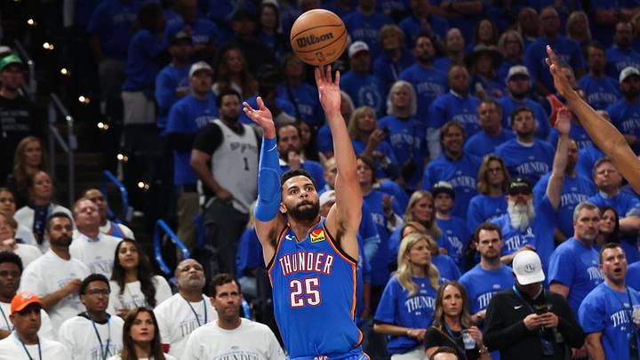 May 20, 2026; Oklahoma City, Oklahoma, USA; Oklahoma City Thunder guard Ajay Mitchell (25) shoots as San Antonio Spurs forward Harrison Barnes (40) defends during the third quarter during game two of the western conference finals for the 2026 NBA playoffs at Paycom Center. Mandatory Credit: Brett Rojo-Imagn Images