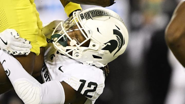 Oct 4, 2024; Eugene, Oregon, USA; Oregon Ducks running back Jordan James (20) is tackeld by Michigan State Spartans defensive back Justin Denson Jr. (12) at Autzen Stadium. Mandatory Credit: Troy Wayrynen-Imagn Images