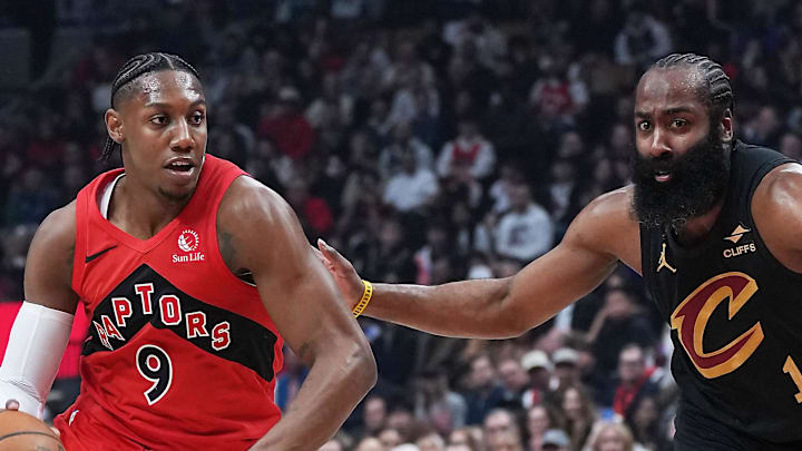 Toronto Raptors forward RJ Barrett controls the ball as Cleveland Cavaliers guard James Harden tries to defend.