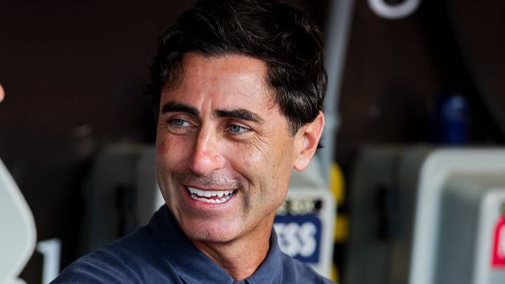 Aug 1, 2025; San Diego, California, USA; San Diego Padres general manager AJ Preller, right, talks with CEO Erik Greupner in the dugout before the game against the St. Louis Cardinals at Petco Park. Mandatory Credit: Chadd Cady-Imagn Images