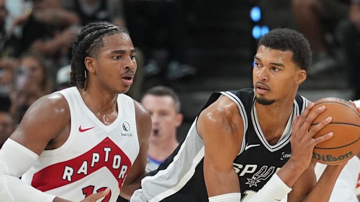 San Antonio Spurs forward/center Victor Wembanyama looks to pass in front of Toronto Raptors forward Collin Murray-Boyles.