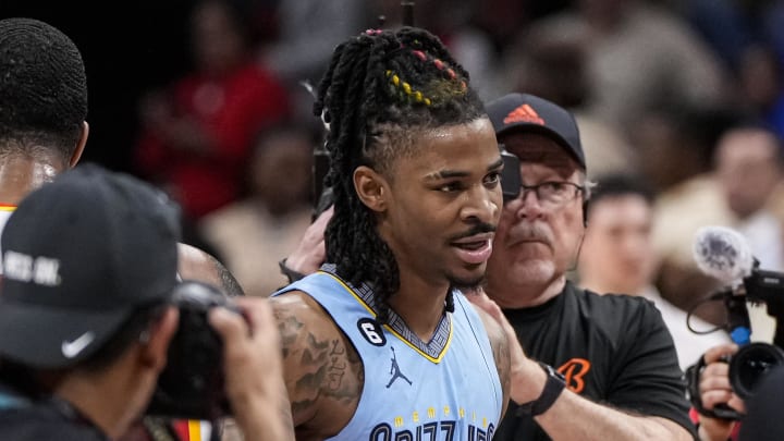 Mar 26, 2023; Atlanta, Georgia, USA; Atlanta Hawks forward John Collins (20) and Memphis Grizzlies guard Ja Morant (12) react after the Grizzlies defeated the Hawks at State Farm Arena. Mandatory Credit: Dale Zanine-USA TODAY Sports