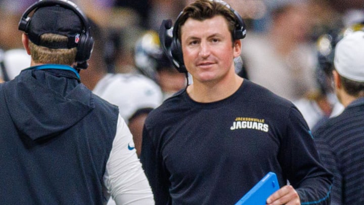 Aug 17, 2025; New Orleans, Louisiana, USA;  Jacksonville Jaguars offensive coordinator Grant Udinski  (blue binder) reacts to a touchdown against the New Orleans Saints during the first half at Caesars Superdome. Mandatory Credit: Stephen Lew-Imagn Images