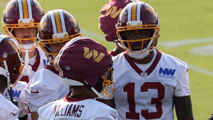 Ashburn, VA, USA; Washington Commanders wide receivers huddle after a drill at training camp. Treylon Burks (13) is competing for a role in a receiver room that now includes Stefon Diggs. At the BigBear.ai Performance Center at Commanders Park. Mandatory Credit: Geoff Burke-Imagn Images Ashburn, VA, USA; Washington Commanders wide receivers huddle after a drill at training camp. Treylon Burks (13) is competing for a role in a receiver room that now includes Stefon Diggs. At the BigBear.ai Performance Center at Commanders Park. Mandatory Credit: Geoff Burke-Imagn Images