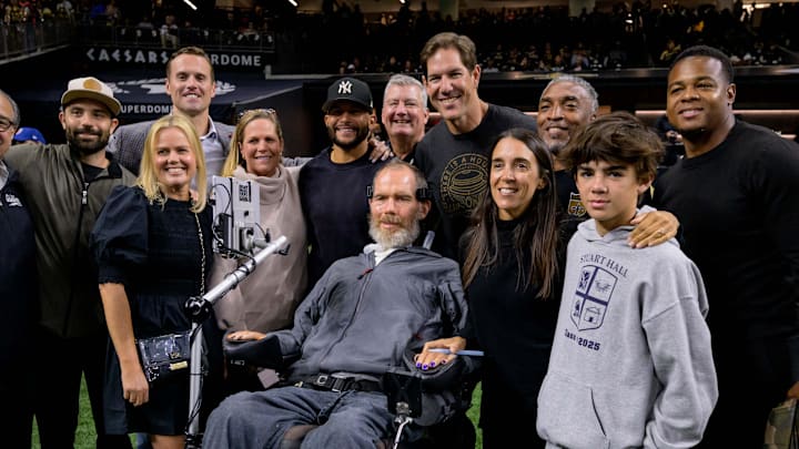 Oct 17, 2024; New Orleans, Louisiana, USA; Former New Orleans Saints pose with Steve Gleason including, back row, Lance Moore, Scott Fujita, Michael Lewis, and Pierre Thomas before a game against the Denver Broncos at Caesars Superdome. Mandatory Credit: Matthew Hinton-Imagn Images