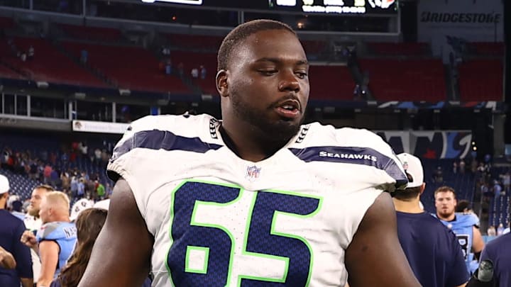 Aug 17, 2024; Nashville, Tennessee, USA; Tennessee Titans safety Mike Brown (44) and Seattle Seahawks offensive tackle Michael Jerrell (65) leaves the field after the game at Nissan Stadium.