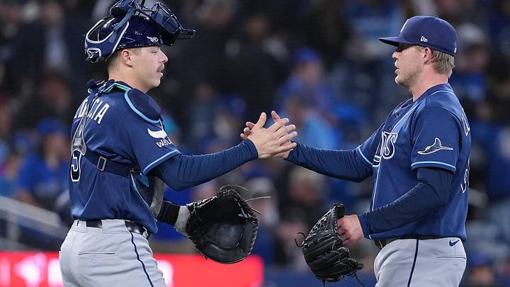 May 12, 2026; Toronto, Ontario, CAN; Tampa Bay Rays catcher Hunter Feduccia (9) celebrates the win with relief pitcher Garrett Cleavinger (60) against the Toronto Blue Jays at the end of the tenth inning at Rogers Centre.
