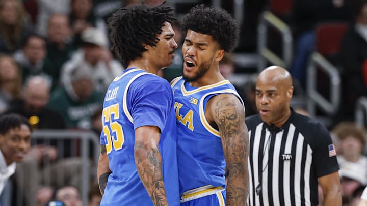 Mar 13, 2026; Chicago, IL, USA; UCLA Bruins guard Donovan Dent (2) celebrates with guard Skyy Clark (55) during the second half at United Center. Mandatory Credit: Kamil Krzaczynski-Imagn Images