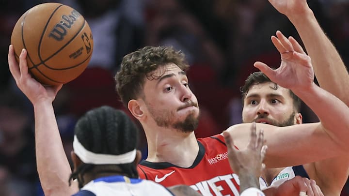 Jan 1, 2025; Houston, Texas, USA; Houston Rockets center Alperen Sengun (28) controls the ball as Dallas Mavericks forward Maxi Kleber (42) defends during the fourth quarter at Toyota Center. Mandatory Credit: Troy Taormina-Imagn Images