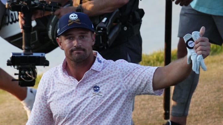 Bryson DeChambeau waves to the gallery as he walks to the 18th green during the third round of the U.S. Open golf tournament. Bryson DeChambeau waves to the gallery as he walks to the 18th green during the third round of the U.S. Open golf tournament.