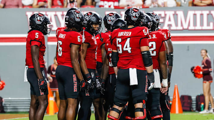 Sep 27, 2025; Raleigh, North Carolina, USA;  North Carolina State Wolfpack huddle during the first half of the game against Virginia Tech Hokies at Carter-Finley Stadium. Mandatory Credit: Jaylynn Nash-Imagn Images