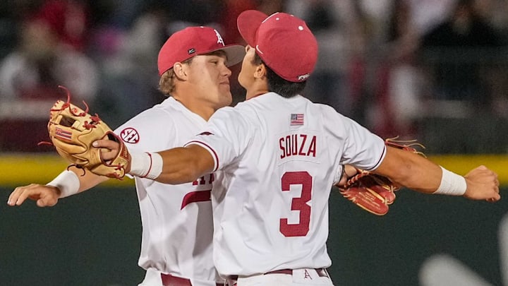 Arkansas Razorbacks infielders Nolan Souza and Camden Kozeal jump in celebration of a 12-4 win over Missouri State at Baum-Walker Stadium, ending a losing streak to the Bears.