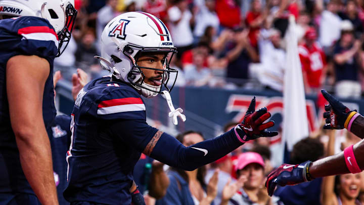 Oct 11, 2025; Tucson, Arizona, USA; Arizona Wildcats wide receiver Kris Hutson (4) celebrates a touchdown he made during the first quarter of the game against the Brigham Young Cougars at Arizona Stadium. Mandatory Credit: Aryanna Frank-Imagn Images Oct 11, 2025; Tucson, Arizona, USA; Arizona Wildcats wide receiver Kris Hutson (4) celebrates a touchdown he made during the first quarter of the game against the Brigham Young Cougars at Arizona Stadium. Mandatory Credit: Aryanna Frank-Imagn Images