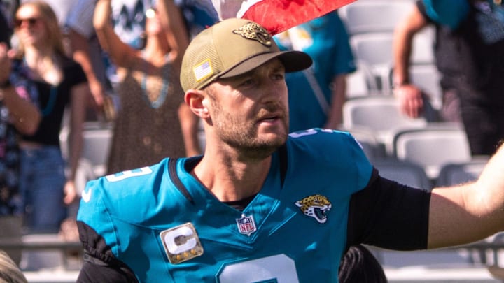 Jacksonville Jaguars punter Logan Cooke (9) enter the field with an American Flag during Salute to Service before the start of an NFL football game at EverBank Stadium, Sunday, November 16, 2025. Jacksonville Jaguars punter Logan Cooke (9) enter the field with an American Flag during Salute to Service before the start of an NFL football game at EverBank Stadium, Sunday, November 16, 2025.