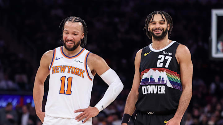 Feb 4, 2026; New York, New York, USA;  New York Knicks guard Jalen Brunson (11) talks with Denver Nuggets guard Jamal Murray (27) during a free throw attempt in the first quarter at Madison Square Garden.