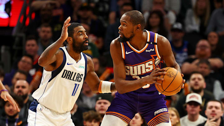 Dec 27, 2024; Phoenix, Arizona, USA; Phoenix Suns forward Kevin Durant (35) handles the ball against Dallas Mavericks guard Kyrie Irving (11) during the third quarter at Footprint Center. Mandatory Credit: Mark J. Rebilas-Imagn Images