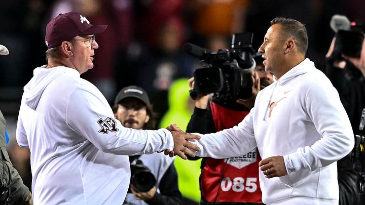 Texas A&M Aggies head coach Mike Elko, left, shakes hands with Texas Longhorns head coach Steve Sarkisian after the game. The Longhorns defeated the Aggies 17-7. at Kyle Field.