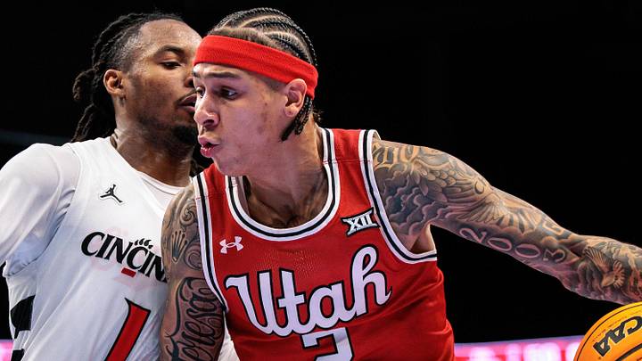 Mar 10, 2026; Kansas City, MO, USA; Utah Utes guard Terrence Brown (2) drives around Cincinnati Bearcats guard Day Day Thomas (1) during the second half at T-Mobile Center. Mandatory Credit: William Purnell-Imagn Images