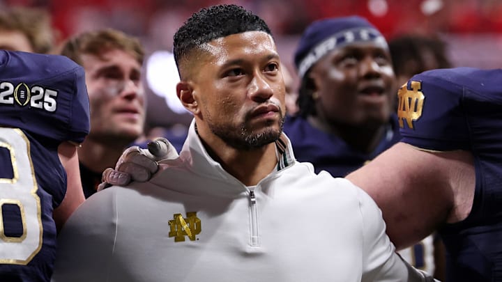 Jan 20, 2025; Atlanta, GA, USA; Notre Dame Fighting Irish offensive lineman Pat Coogan (78), head coach Marcus Freeman, and offensive lineman Rocco Spindler (50) react after losing against the Ohio State Buckeyes in the CFP National Championship college football game at Mercedes-Benz Stadium. 
