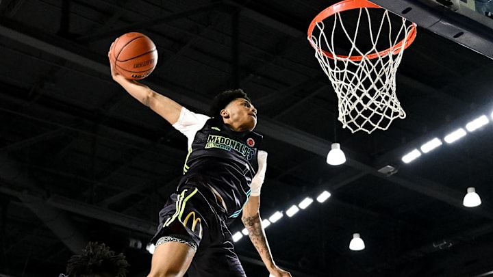 Apr 1, 2024; Houston, TX, USA; McDonalds High School All American guard Jalil Bethea (1) jumps over seven foot two center J.Bol (7) and dunks the ball during the dunk competition in the 2024 McDonalds High School All American Powerade Jam Fest at Delmar Fieldhouse. Mandatory Credit: Maria Lysaker-Imagn Images