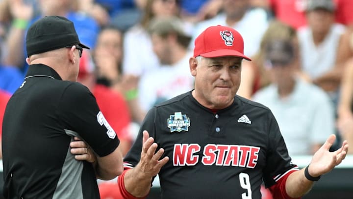 Jun 15, 2024; Omaha, NE, USA; NC State Wolfpack head coach Elliott Avent discusses a balk call with an umpire in the game against the Kentucky Wildcats during the eighth inning at Charles Schwab Field Omaha. Mandatory Credit: Steven Branscombe-Imagn Images Jun 15, 2024; Omaha, NE, USA; NC State Wolfpack head coach Elliott Avent discusses a balk call with an umpire in the game against the Kentucky Wildcats during the eighth inning at Charles Schwab Field Omaha. Mandatory Credit: Steven Branscombe-Imagn Images