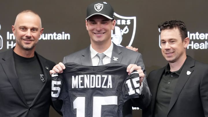 Apr 24, 2026; Henderson, NV, USA; Las Vegas Raiders quarterback Fernando Mendoza (center) poses with jersey with general manager John Spytek (left) and head coach Klint Kubiak  at introductory press conference at Intermountain Health Performance Center after being selected as the No. 1 pick in the 2026 NFL Draft. Mandatory Credit: Kirby Lee-Imagn Images