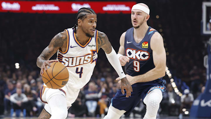 Apr 22, 2026; Oklahoma City, Oklahoma, USA; Phoenix Suns guard Jalen Green (4) drives around Oklahoma City Thunder guard Alex Caruso (9) in the first half during game two of the first round of the 2026 NBA Playoffs at Paycom Center. Mandatory Credit: Alonzo Adams-Imagn Images