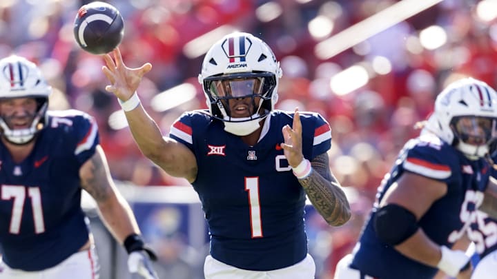 Nov 8, 2025; Tucson, Arizona, USA; Arizona Wildcats quarterback Noah Fifita (1) throws a touchdown pass against the Kansas Jayhawks in the first half at Arizona Stadium. Mandatory Credit: Mark J. Rebilas-Imagn Images Nov 8, 2025; Tucson, Arizona, USA; Arizona Wildcats quarterback Noah Fifita (1) throws a touchdown pass against the Kansas Jayhawks in the first half at Arizona Stadium. Mandatory Credit: Mark J. Rebilas-Imagn Images