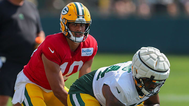 Green Bay Packers quarterback Jordan Love (10) takes a snap from offensive lineman Elgton Jenkins (74) during the eighth practice of training camp on Wednesday, July 31, 2024, at Ray Nitschke Field in Ashwaubenon, Wis.
