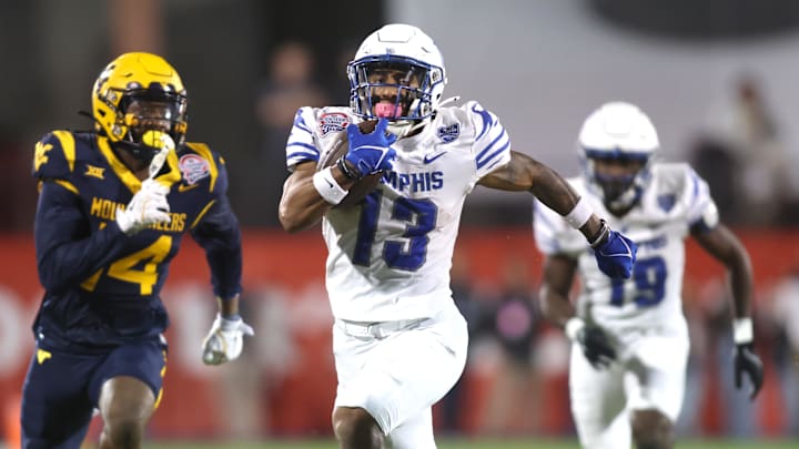 Dec 17, 2024; Frisco, TX, USA; Memphis Tigers running back Greg Desrosiers Jr. (13) runs for a touchdown against the West Virginia Mountaineers in the second quarter at Toyota Stadium. Dec 17, 2024; Frisco, TX, USA; Memphis Tigers running back Greg Desrosiers Jr. (13) runs for a touchdown against the West Virginia Mountaineers in the second quarter at Toyota Stadium.