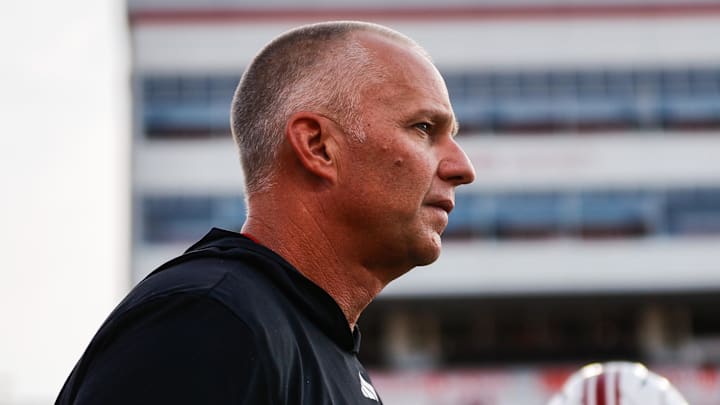 Aug 28, 2025; Raleigh, North Carolina, USA; North Carolina State Wolfpack head coach Dave Doeren looks on during the warmups prior to the game against East Carolina Pirates at Carter-Finley Stadium. Mandatory Credit: Jaylynn Nash-Imagn Images