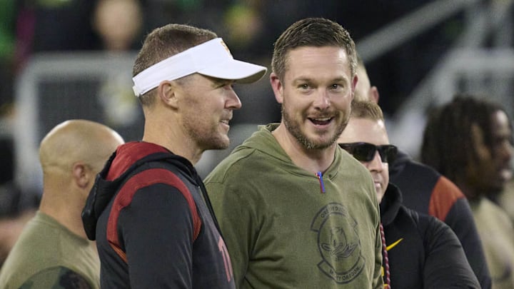 Nov 11, 2023; Eugene, Oregon, USA; USC Trojans head coach Lincoln Riley, left, and Oregon Ducks head coach Dan Lanning talk before a game at Autzen Stadium. Mandatory Credit: Troy Wayrynen-Imagn Images