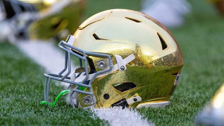 Sep 13, 2025; South Bend, Indiana, USA; A gold Notre Dame Fighting Irish helmet on the field before a game against the Texas A&M Aggies at Notre Dame Stadium. 