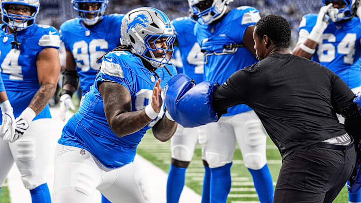 Detroit Lions defensive tackle Tyleik Williams (91), center, warms up ahead of the Houston Texans game