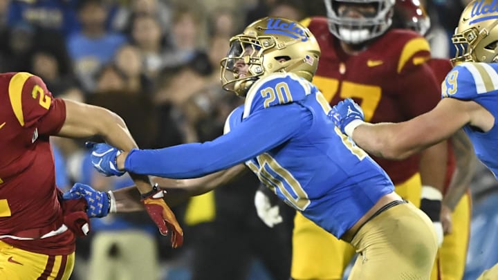 Nov 23, 2024; Pasadena, California, USA; USC Trojans wide receiver Duce Robinson (2) tries to run past UCLA Bruins linebacker Kain Medrano (20) during the second quarter at Rose Bowl. Mandatory Credit: Robert Hanashiro-Imagn Images