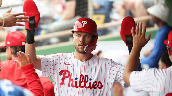 Mar 24, 2025; Clearwater, Florida, USA; Philadelphia Phillies shortstop Trea Turner (7) is congratulated after he scored a run during the first inning against the Tampa Bay Rays  at BayCare Ballpark. 
