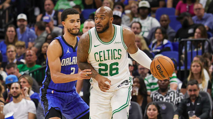 Apr 9, 2025; Orlando, Florida, USA; Boston Celtics forward Xavier Tillman (26) passes the ball in front of Orlando Magic guard Caleb Houstan (2) during the second half at Kia Center. Mandatory Credit: Mike Watters-Imagn Images