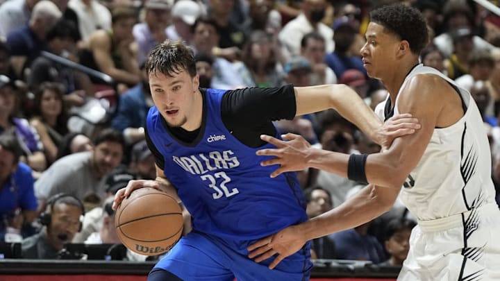 Dallas Mavericks forward Cooper Flagg drives past San Antonio Spurs forward Carter Bryant.