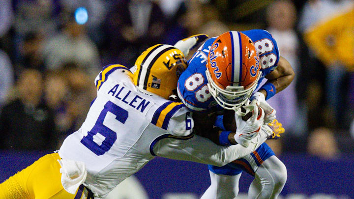 Nov 11, 2023; Baton Rouge, Louisiana, USA; LSU Tigers safety Jordan Allen (6) tackles Florida Gators wide receiver Marcus Burke (88)  during the second half at Tiger Stadium. Mandatory Credit: Stephen Lew-Imagn Images