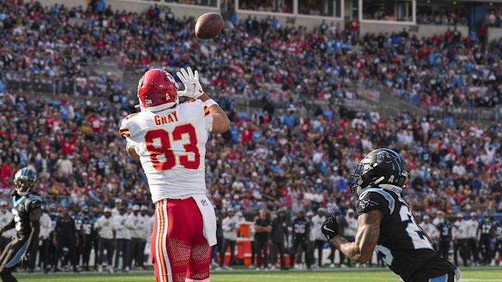 Nov 24, 2024; Charlotte, North Carolina, USA; Kansas City Chiefs tight end Noah Gray (83) catches a touchdown pass guarded by Carolina Panthers safety Xavier Woods (25) during the second quarter at Bank of America Stadium. Mandatory Credit: Jim Dedmon-Imagn Images