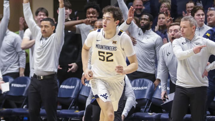 Jan 6, 2026; Morgantown, West Virginia, USA; West Virginia Mountaineers guard Treysen Eaglestaff (52) celebrates after a made three pointer basket during the second half against the Cincinnati Bearcats at Hope Coliseum. Mandatory Credit: Ben Queen-Imagn Images