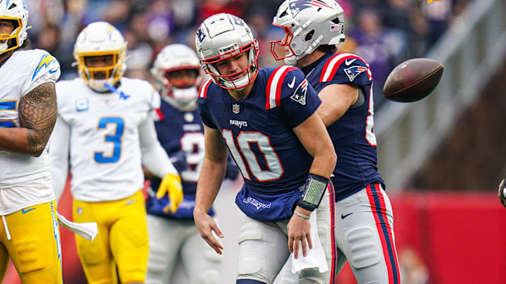 Dec 28, 2024; Foxborough, Massachusetts, USA; Los Angeles Chargers linebacker Junior Colson (25) called for roughing the passer against New England Patriots quarterback Drake Maye (10) in the second half at Gillette Stadium. Mandatory Credit: David Butler II-Imagn Images