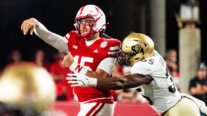 Sep 7, 2024; Lincoln, Nebraska, USA; Nebraska Cornhuskers quarterback Dylan Raiola (15) throws as he’s hit by Colorado Buffaloes defensive end BJ Green II (35) during the third quarter at Memorial Stadium. 
