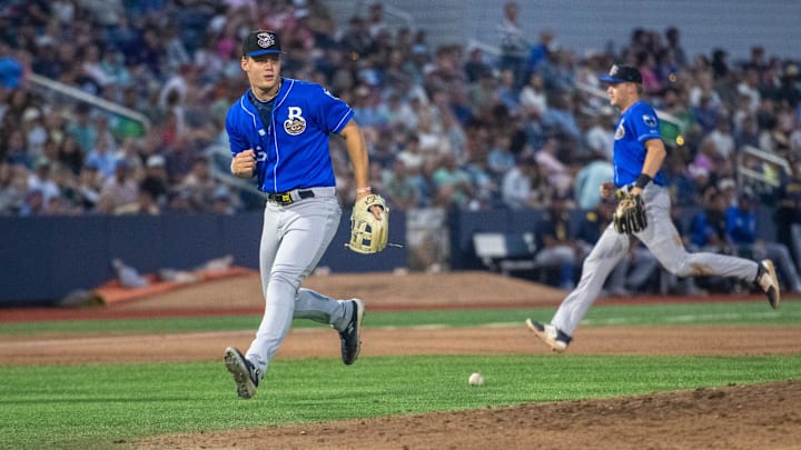 The Blue Wahoos load the bases as Biloxi Shuckers third baseman Brock Wilken (25) can't find the handle on a soft grounder during the opening night of the baseball season in Pensacola on Friday, April 4, 2025.