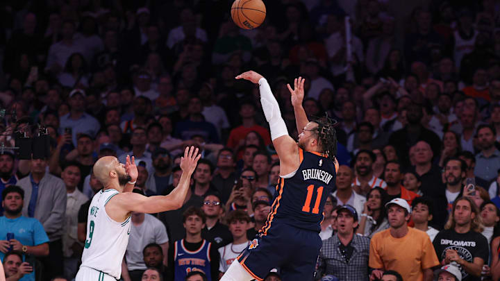 May 12, 2025; New York, New York, USA; New York Knicks guard Jalen Brunson (11) makes a basket in front ofBoston Celtics guard Derrick White (9) in the second half during game four of the second round for the 2025 NBA Playoffs at Madison Square Garden. Mandatory Credit: Vincent Carchietta-Imagn Images