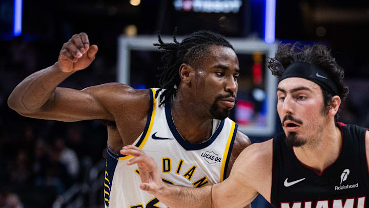 Miami Heat guard Jaime Jaquez Jr. dribbles the ball while Indiana Pacers guard/forward Aaron Nesmith defends.