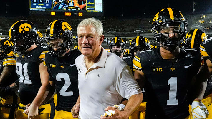 Iowa Hawkeyes head coach Kirk Ferentz runs off the field with his players after becoming the winningest coach in Big Ten history, passing Woody Hayes, with a win over the Massachusetts Minutemen Sept. 13, 2025 at Kinnick Stadium in Iowa City, Iowa.